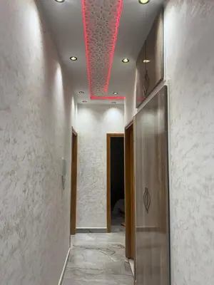 a hallway with a red light on the ceiling at Appartement Fès standing in Fès