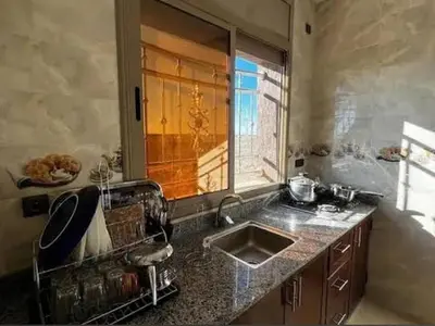 a kitchen with a sink and a window at merzouga apartment in Merzouga