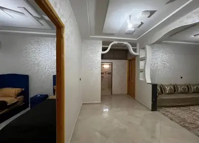 a living room with a couch and a bed in a room at merzouga apartment in Merzouga
