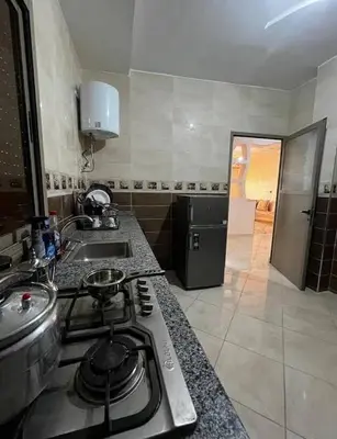 a kitchen with a stove top and a sink at merzouga apartment in Merzouga