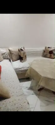 a bedroom with a bed and a couch at Amir's home in Meknès