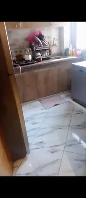 a kitchen with an open door to a counter top at Amir's home in Meknès