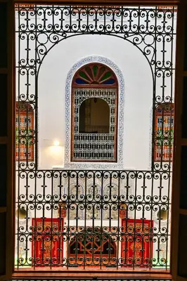 an iron fence with a mirror behind it at Riad Les Émeraudes De Fes in Fès
