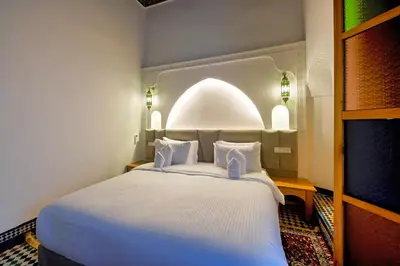 a bedroom with a large white bed in a room at Riad Les Émeraudes De Fes in Fès