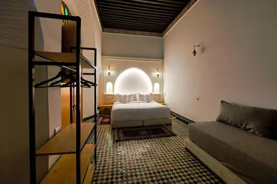 a bedroom with a bed and a couch in a room at Riad Les Émeraudes De Fes in Fès