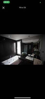 a large bathroom with a tub and a window at Vila en fes in Fès