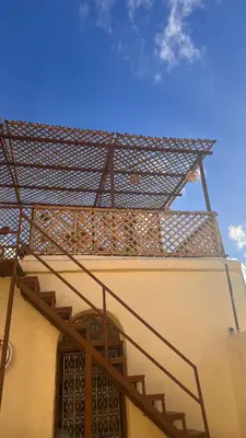 a metal staircase on the side of a building at Dar Al Rcif in Station Bab Ftouh