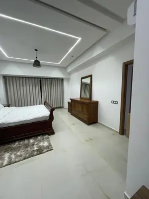 a bedroom with a bed and a mirror at Hotel kairouan in Fès
