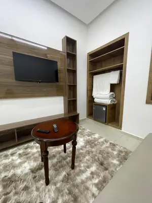 a room with a coffee table and a tv at Hotel kairouan in Fès