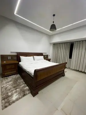 a bedroom with a large bed and a pendant light at Hotel kairouan in Fès