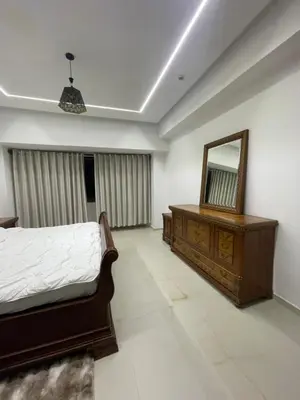 a bedroom with a bed and a mirror and a dresser at Hotel kairouan in Fès