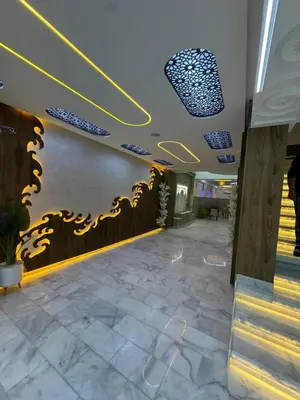 a lobby of a building with yellow and blue lights at Hotel kairouan in Fès