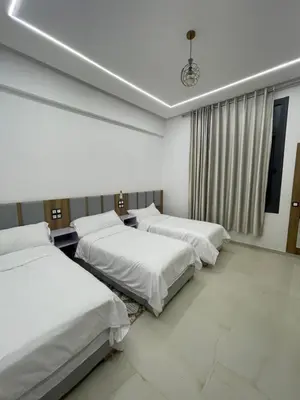 a room with three beds and a window at Hotel kairouan in Fès