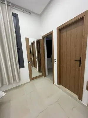 a room with three doors and a mirror at Hotel kairouan in Fès