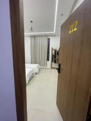 a door to a bedroom with a bed in a room at Hotel kairouan in Fès