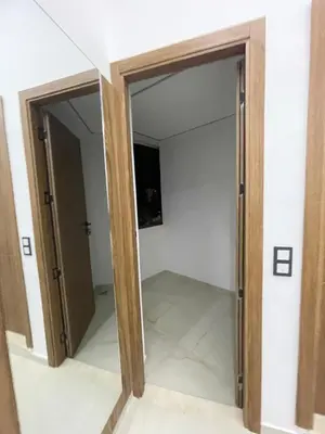 two doors in a room with a mirror at Hotel kairouan in Fès