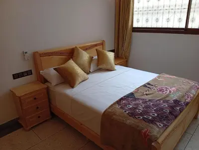 a bedroom with a bed with pillows and a window at Dar AWRABIA in Fès