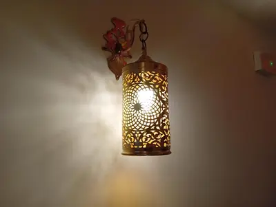 a glass lantern hanging from a wall at Dar AWRABIA in Fès