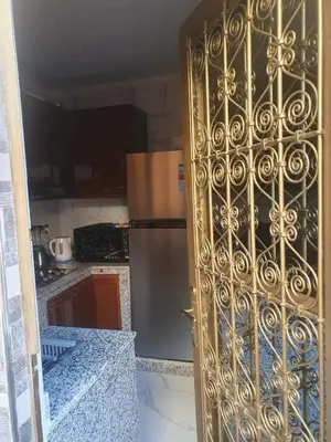 a kitchen with a gold door in a kitchen at Dar AWRABIA in Fès