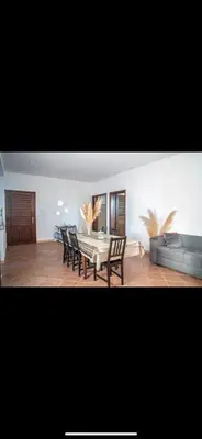 a living room with a table and chairs and a couch at Appartement très spacieux au coeur de Temara à 10 minutes du grand stade de Rabat in Oulad Akkou