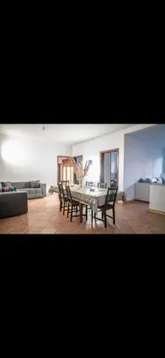 a living room with a table and chairs and a couch at Appartement très spacieux au coeur de Temara à 10 minutes du grand stade de Rabat in Oulad Akkou