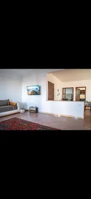 a living room with a couch and a table at Appartement très spacieux au coeur de Temara à 10 minutes du grand stade de Rabat in Oulad Akkou