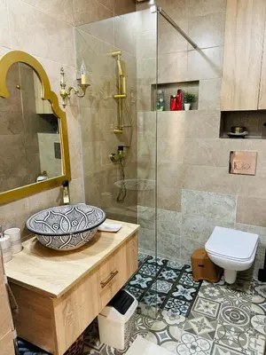 a bathroom with a sink and a shower at Central, modern and well-equipped apartment in Oulad Akkou
