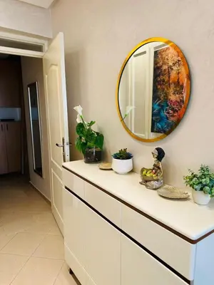 a bathroom with a counter with a mirror on the wall at Central, modern and well-equipped apartment in Oulad Akkou