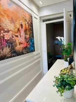a painting hanging on a wall next to a table at Central, modern and well-equipped apartment in Oulad Akkou