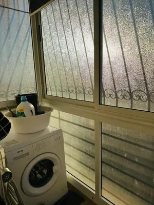 a washing machine in a room with a window at Central, modern and well-equipped apartment in Oulad Akkou
