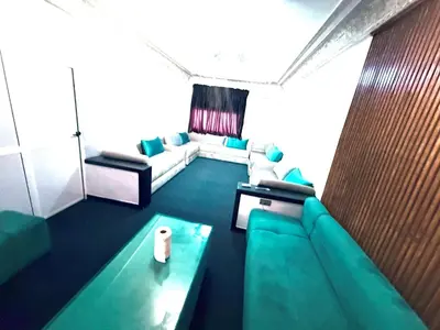 a living room with a couch and a table at Fes Apartment 2 in Fès