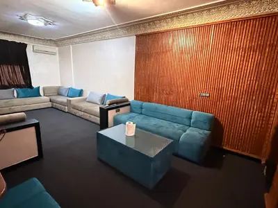 a living room with a couch and a table at Fes Apartment 2 in Fès