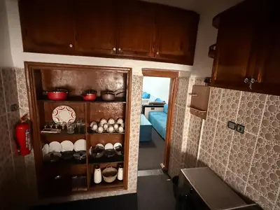 a kitchen with a cupboard filled with pots and pans at Fes Apartment 2 in Fès