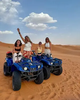 a group of women riding atvs in the desert at Morocco Sahara Desert Camp in Merzouga