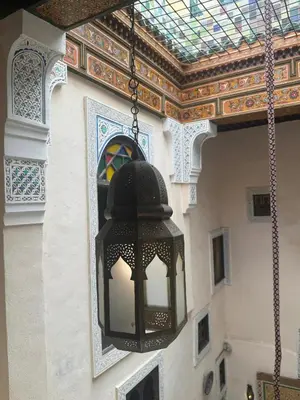 a black light hanging from a building with a ceiling at PanoramicFES Riad in Fès