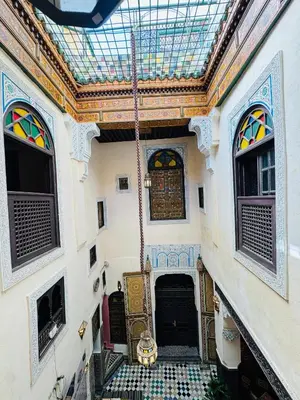 a building with a window and a door with a tile floor at PanoramicFES Riad in Fès