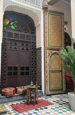 an entry to a mosque with a door and a table at PanoramicFES Riad in Fès