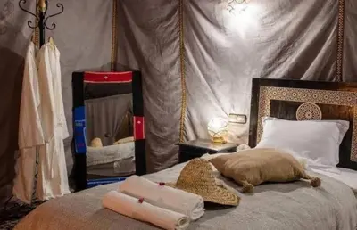 a bedroom with a bed with two towels on it at luxury camp Oasis Opal in Merzouga