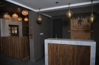 a bar in a restaurant with pendant lights at La Perle de Setti Fadma in Ourika
