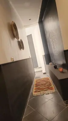 a hallway with a rug on the floor in a house at La Perle de Setti Fadma in Ourika