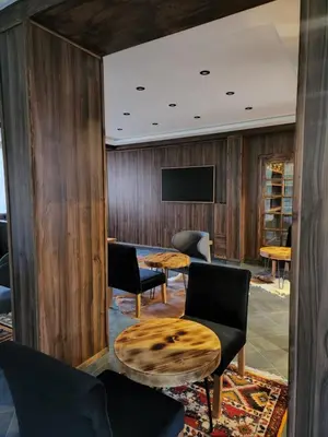 a room with a table and chairs and a tv at La Perle de Setti Fadma in Ourika