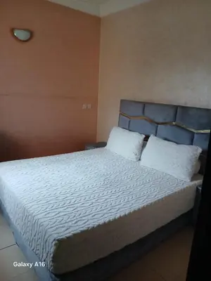 a bedroom with a large bed with white sheets and pillows at jardaine d'Ifrane in Ifrane