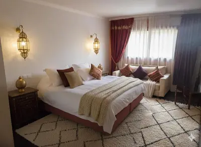 a bedroom with a large bed and a couch at Superbe appartement duplex à l'hivernage in Oulad Akkou