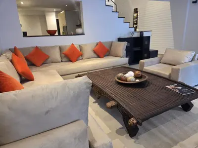 a living room with a couch and a table at Superbe appartement duplex à l'hivernage in Oulad Akkou