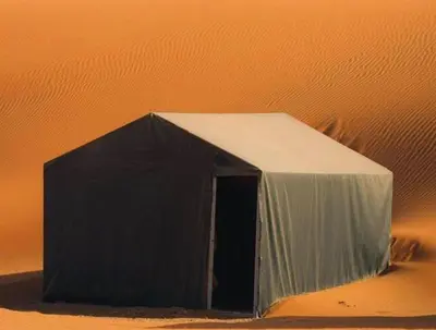 a black and white tent in the desert at beststaysbylocal in Merzouga