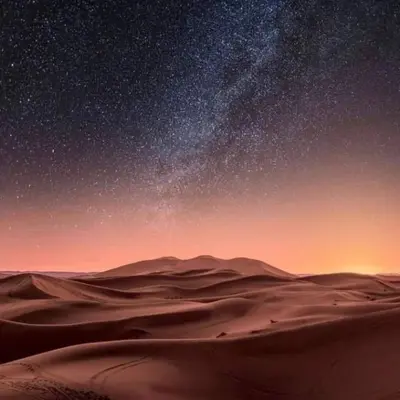 a starry night in a desert with the milky way at beststaysbylocal in Merzouga