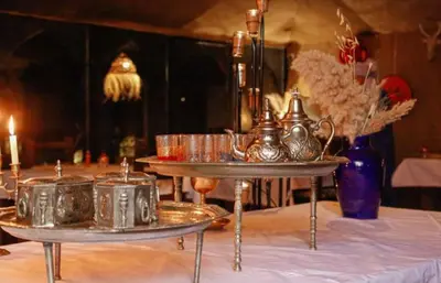 a table with two silver trays on top of it at Luxury Stars Camp in Merzouga