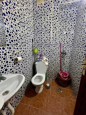 a bathroom with a white toilet and a sink at Maison confortable à Ifrane À louer in Ifrane