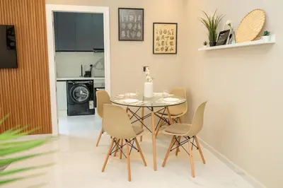 a dining room with a table and chairs at Chic Beachfront Studio Appartment in Oulad Akkou