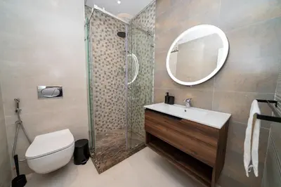 a bathroom with a toilet sink and a shower at Chic Beachfront Studio Appartment in Oulad Akkou